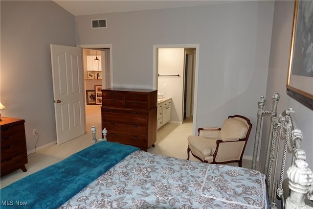 carpeted bedroom featuring ensuite bathroom