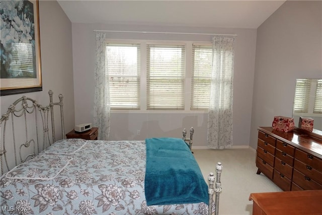 carpeted bedroom with vaulted ceiling