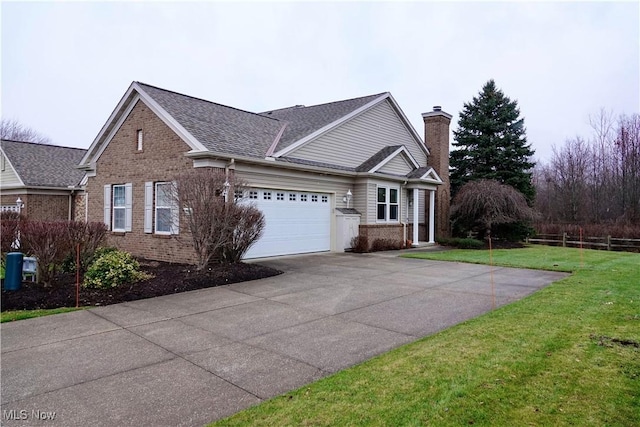 view of front of property featuring a front yard and a garage