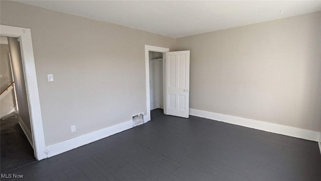 unfurnished bedroom featuring dark hardwood / wood-style floors