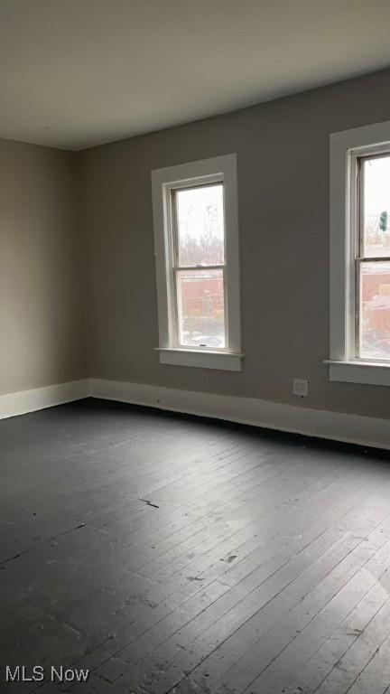 spare room with hardwood / wood-style floors