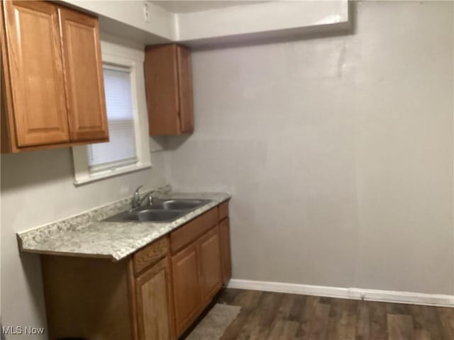 kitchen featuring dark wood-type flooring and sink