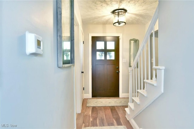 entrance foyer featuring hardwood / wood-style floors and a textured ceiling