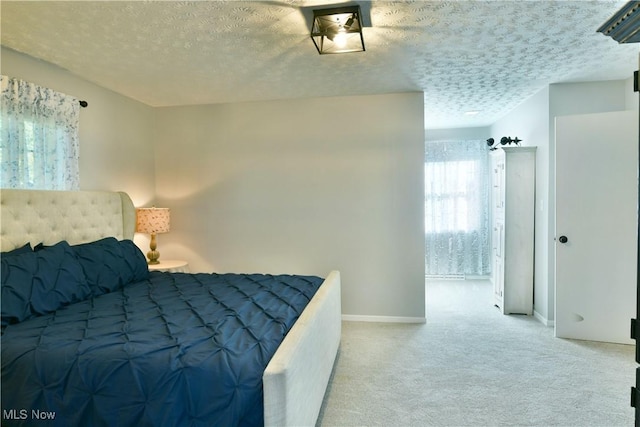 carpeted bedroom with a textured ceiling