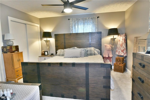 carpeted bedroom with a closet and ceiling fan