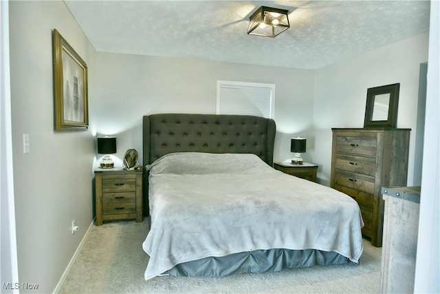 carpeted bedroom with a textured ceiling