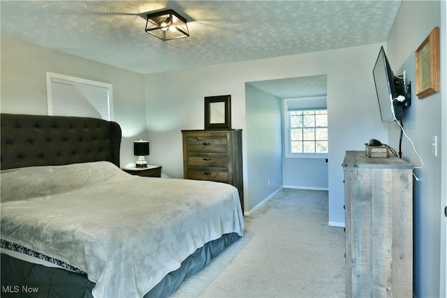 carpeted bedroom with a textured ceiling