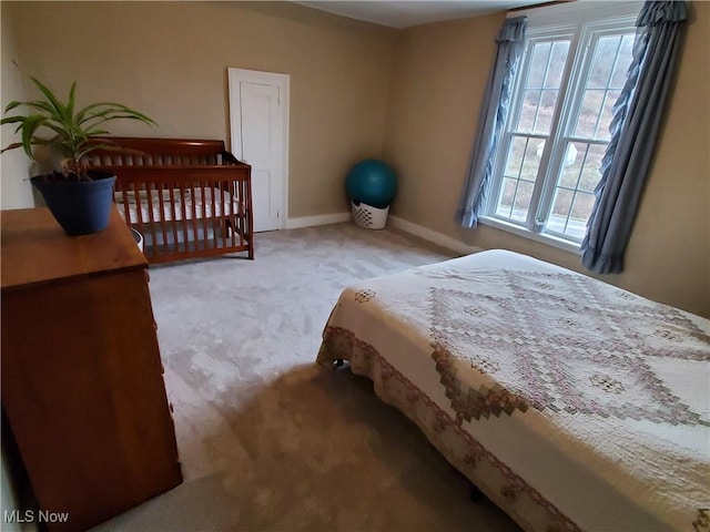 carpeted bedroom featuring baseboards