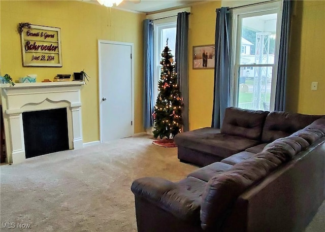 carpeted living room with ornamental molding