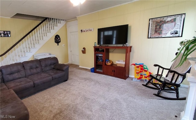 carpeted living room with crown molding, baseboards, and stairway