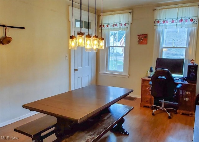 home office featuring baseboards and wood finished floors