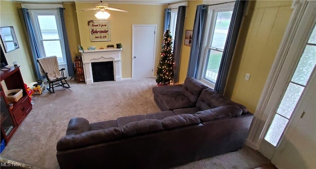 carpeted living room with ceiling fan