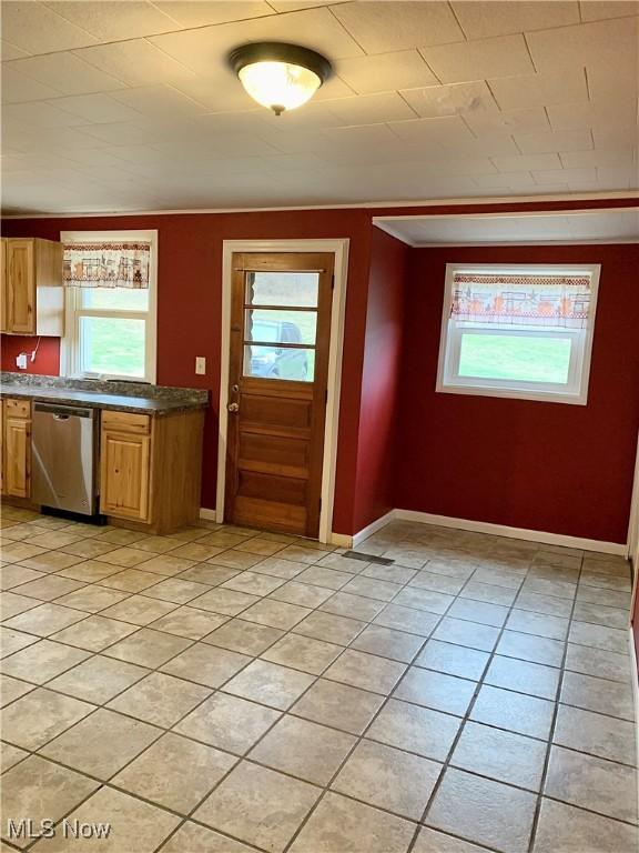 kitchen with dishwasher, light tile patterned flooring, and plenty of natural light