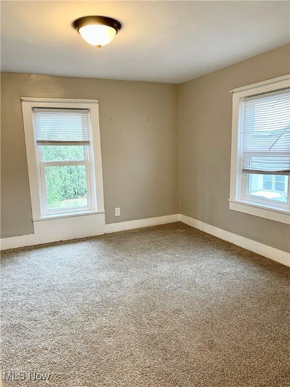 empty room with carpet and plenty of natural light