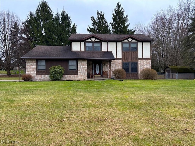 tudor-style house featuring a front lawn