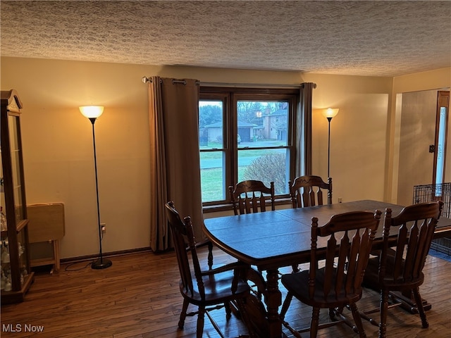 dining room featuring dark hardwood / wood-style floors and a textured ceiling