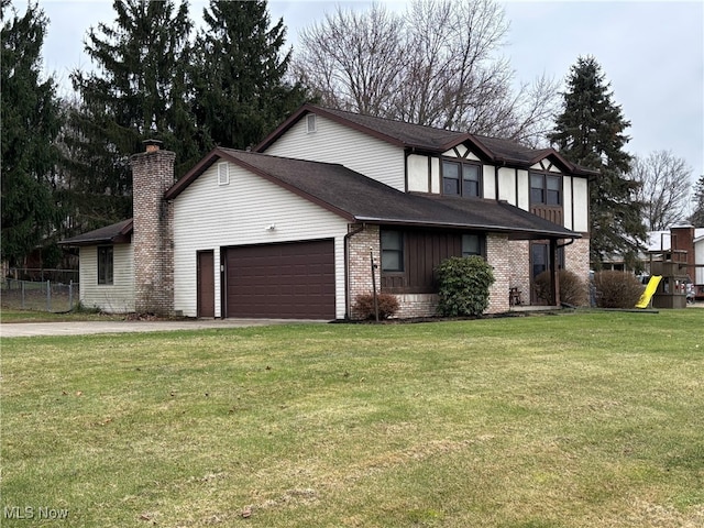 view of front of home with a front yard and a garage