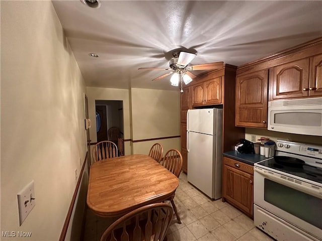 kitchen with white appliances and ceiling fan