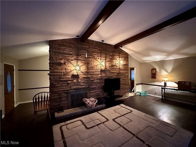 living room with a stone fireplace, hardwood / wood-style flooring, and vaulted ceiling with beams