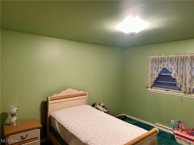 carpeted bedroom featuring baseboard heating