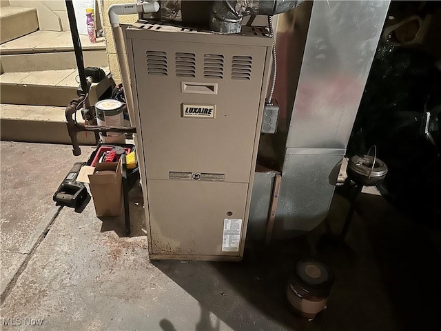 utility room featuring heating unit