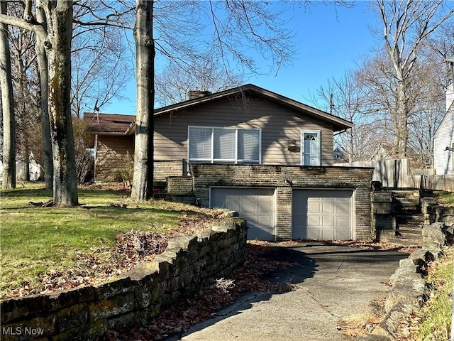 view of front of property with a front lawn and a garage