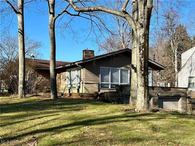 exterior space with a lawn and a garage