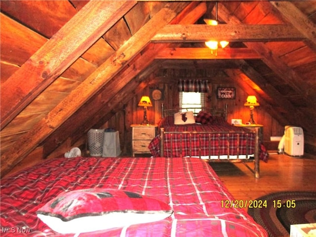 71352 Skyline Dr, Piedmont, OH 43983 - bedroom with lofted ceiling with beams, wood walls, and wood finished floors