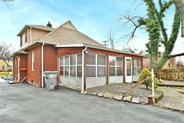 rear view of property with a sunroom