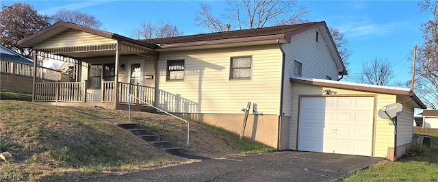 view of front of house featuring a porch and a garage