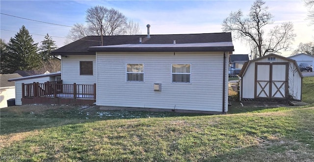 rear view of property with a lawn, a storage unit, and a deck