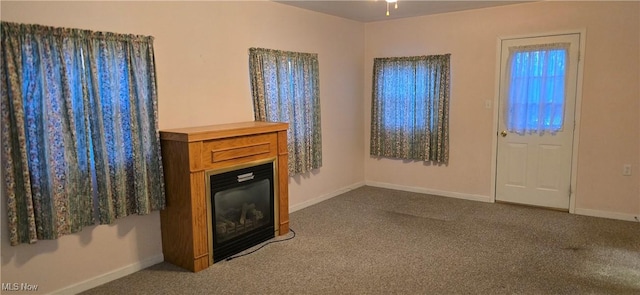 unfurnished living room featuring carpet flooring