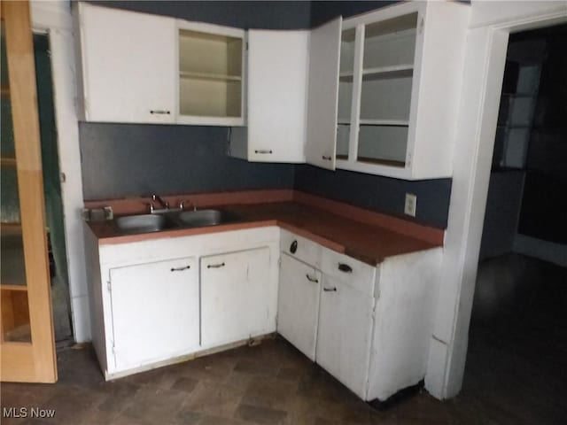 kitchen featuring white cabinetry and sink