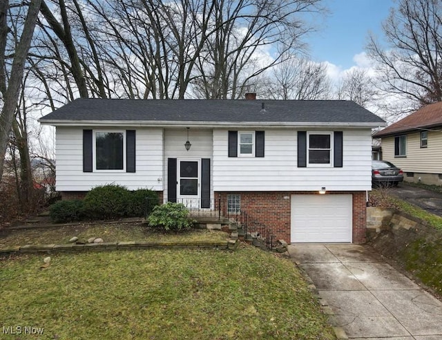 bi-level home with a garage and a front yard