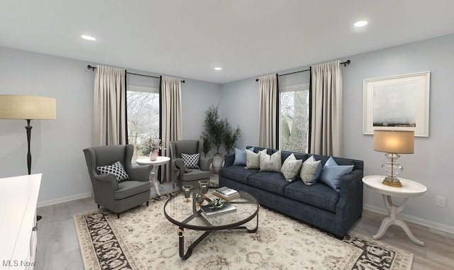 living room with plenty of natural light and light hardwood / wood-style flooring