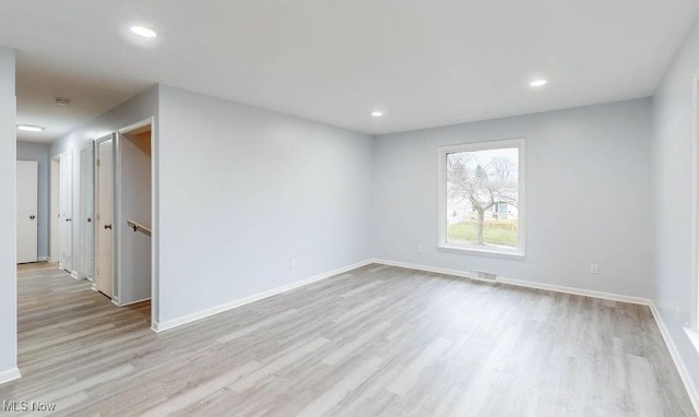 spare room featuring light wood-type flooring