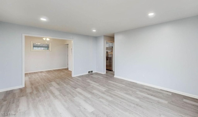 unfurnished room with light wood-type flooring