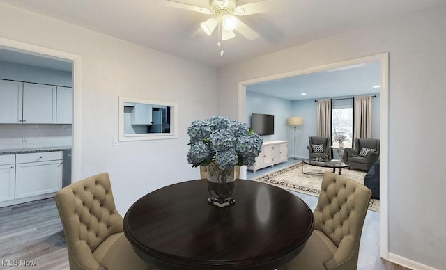 dining area featuring ceiling fan and light wood-type flooring