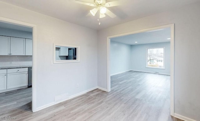 unfurnished room featuring ceiling fan and light wood-type flooring