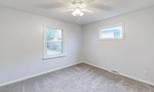 spare room featuring carpet and ceiling fan