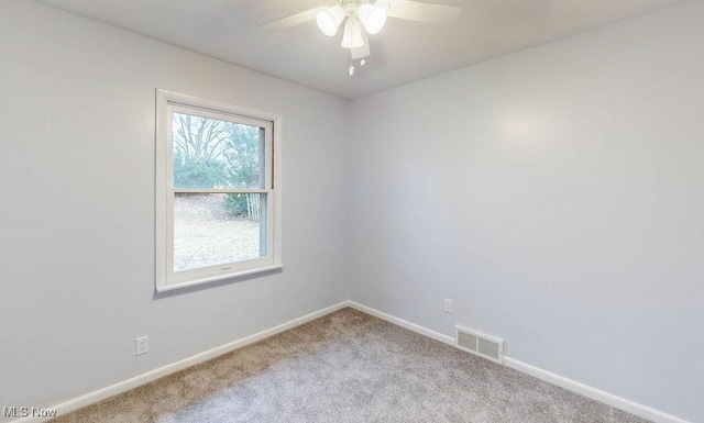 unfurnished room featuring light colored carpet and ceiling fan