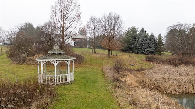 view of yard featuring a gazebo and a water view