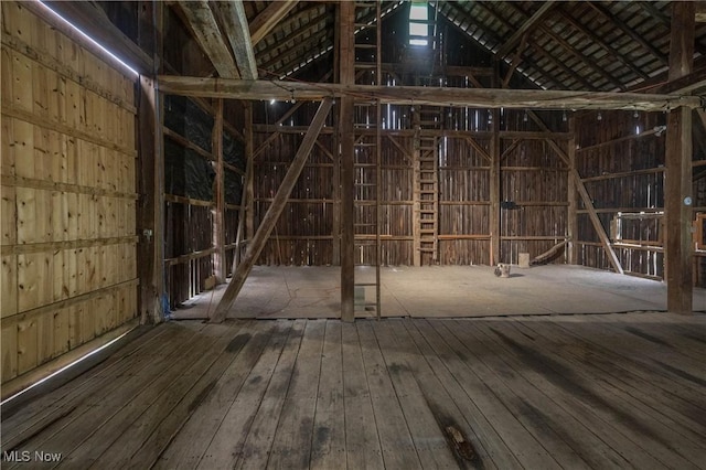 misc room featuring hardwood / wood-style floors and lofted ceiling