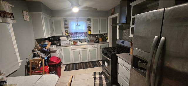 kitchen with white cabinets, ceiling fan, decorative backsplash, and appliances with stainless steel finishes