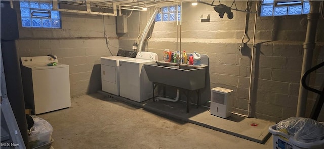 clothes washing area featuring washer and clothes dryer and sink