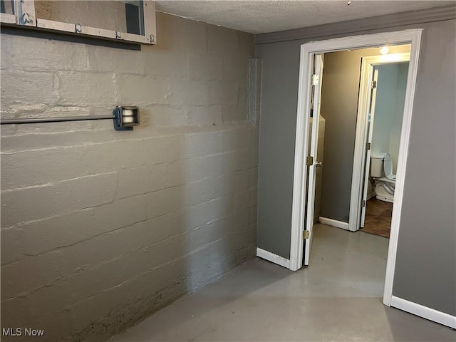 basement featuring a textured ceiling