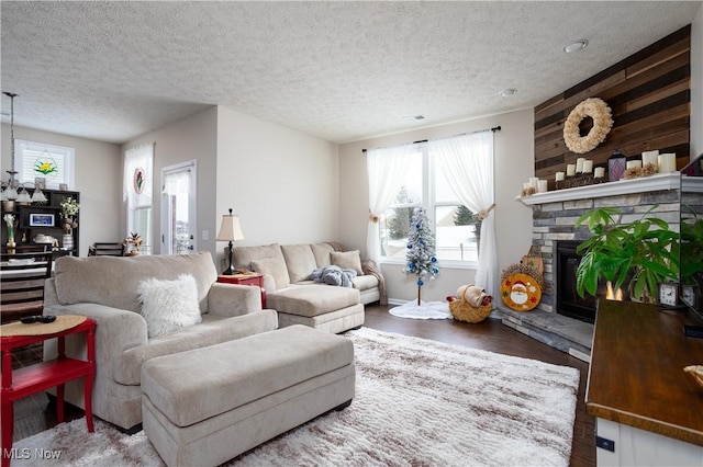 living room with a fireplace, wood-type flooring, and a textured ceiling