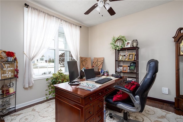 office featuring ceiling fan, wood-type flooring, and a textured ceiling