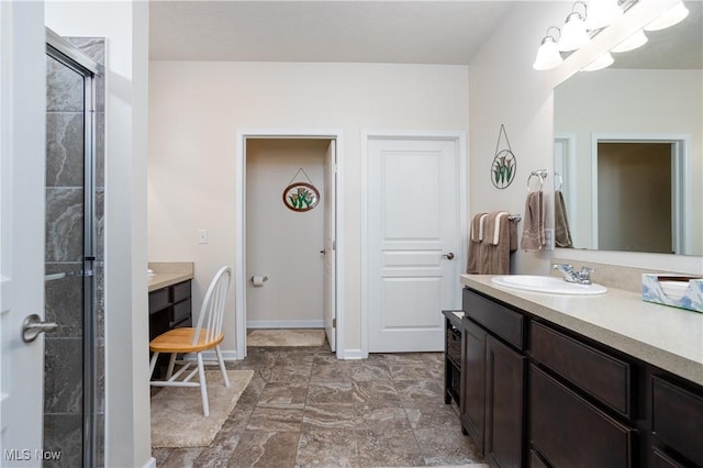 bathroom with vanity and a shower with shower door