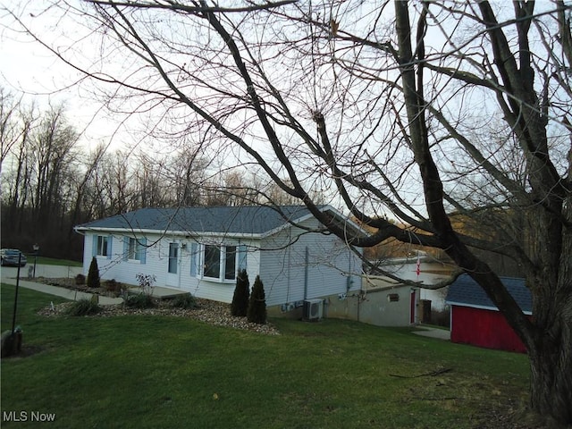 view of home's exterior featuring a lawn and cooling unit